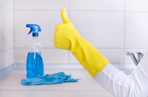 Trained cleaner using professional carpet cleaning equipment in a Dalston property